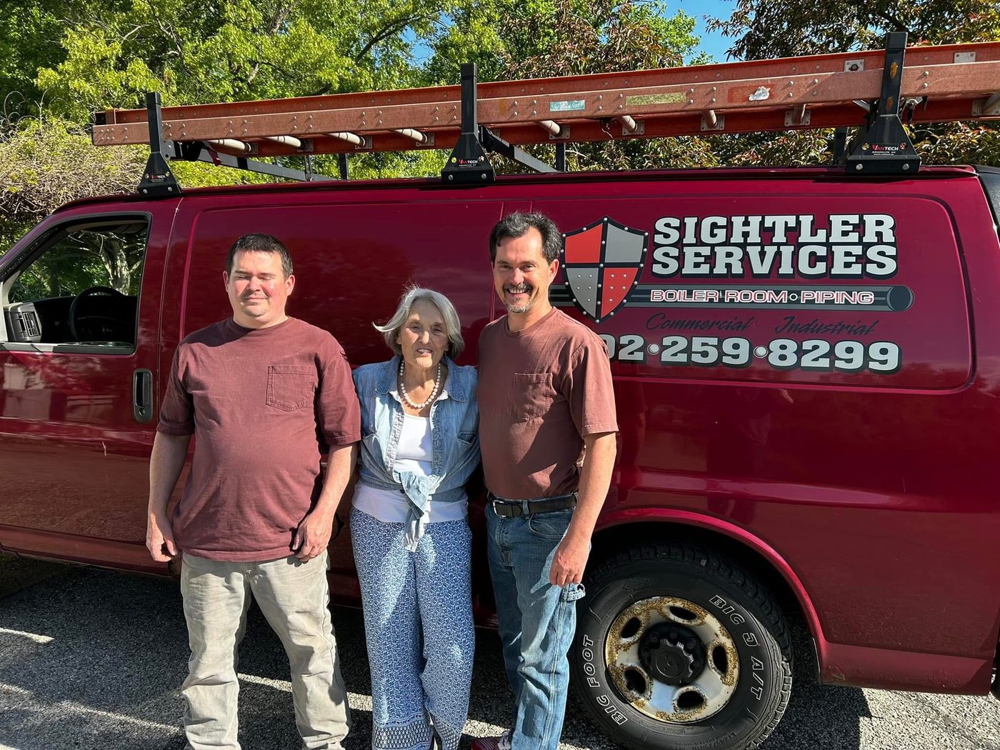The Sightler family in front of the Sightler Services van