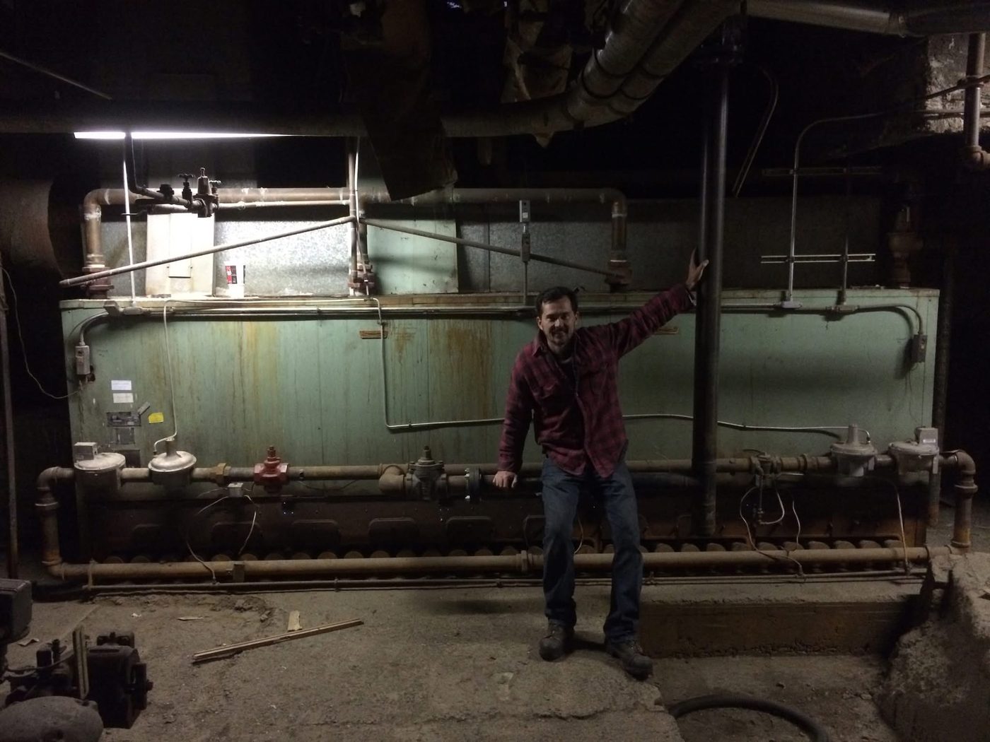 Sightler Services technician inspecting boiler room piping